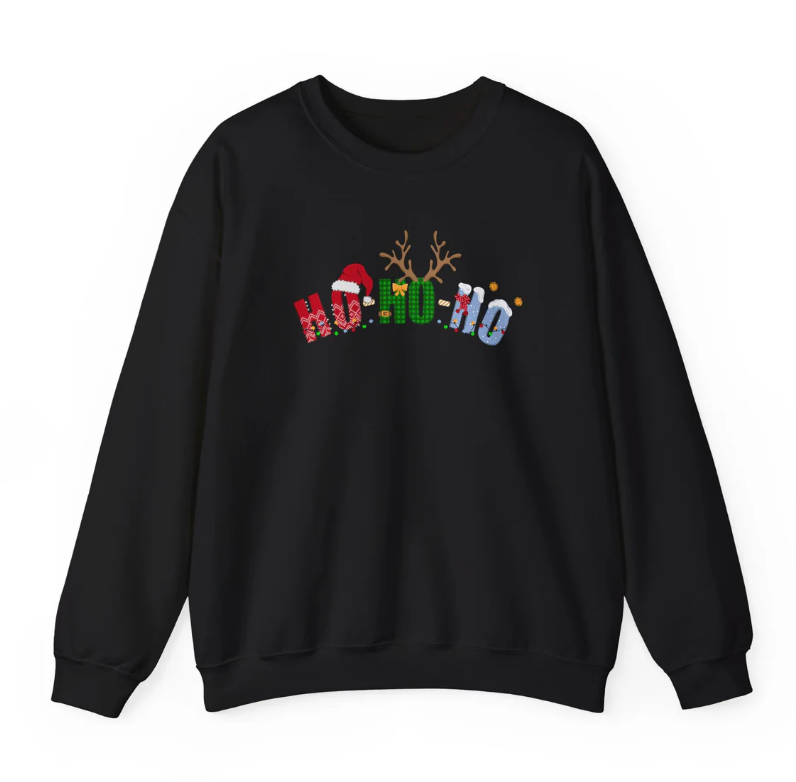 Black Christmas sweatshirt with festive letters spelling ‘Ho Ho Ho,’ decorated with a Santa hat, reindeer antlers, snowflakes, and holiday patterns