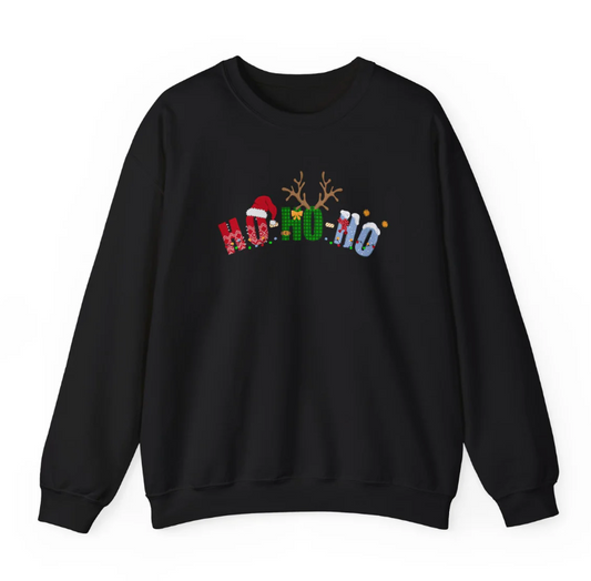 Black Christmas sweatshirt with festive letters spelling ‘Ho Ho Ho,’ decorated with a Santa hat, reindeer antlers, snowflakes, and holiday patterns