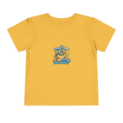 Cute smart bear kids shirt featuring Milo from the Tiny Trouble Club reading a book — educational graphic tee for toddlers and children.